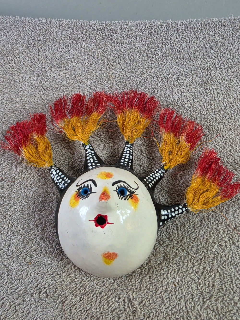 Handcrafted Coconut Shell Sun Face Wall Art with Red and Yellow Tassels